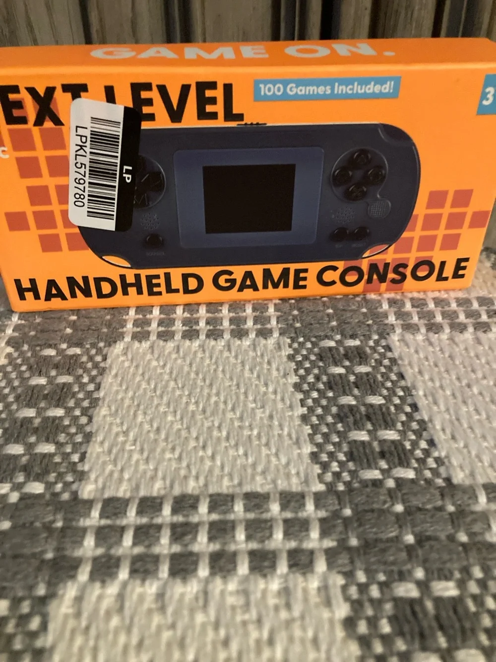 Next Level Apparel Handheld Game Console - Orange Box, Blue Device
